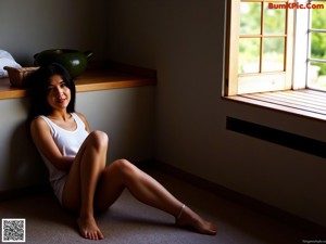 A woman in a red thong posing in front of a window.