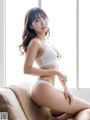 A woman in a white lingerie sitting on a bed.