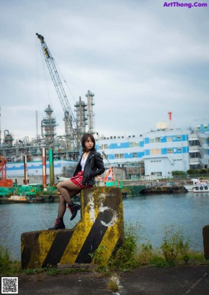 A woman sitting on the steps of a building.