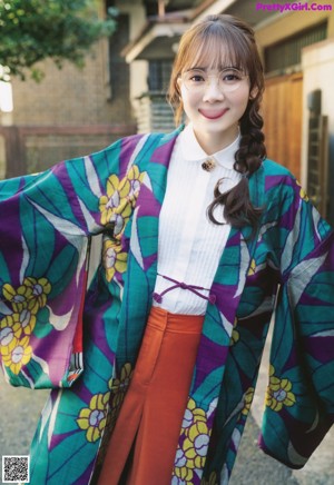 A woman wearing glasses standing in front of a stream.