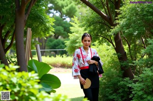 A woman in a black and pink kimono posing for a picture.