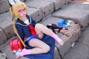 A woman in a school uniform sitting on some steps.