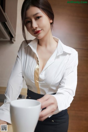 A woman in a pink bra is putting on her underwear.