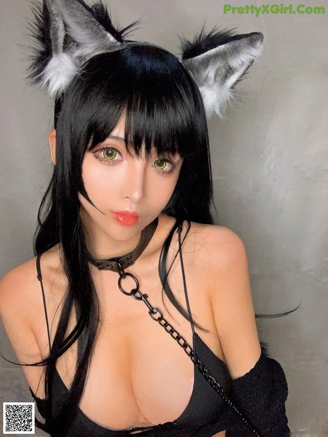 A woman with long black hair wearing a cat ears headband.