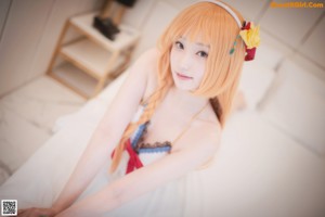 A woman with long orange hair wearing a white bikini.
