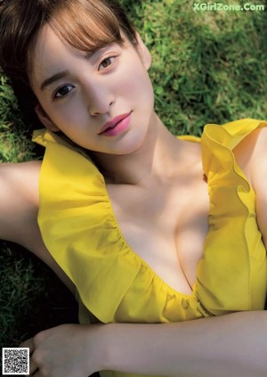 A woman in a white dress is posing for a picture.